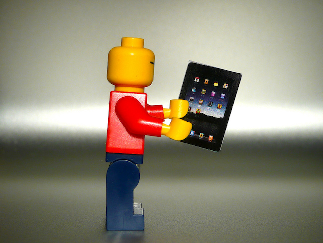 Lego holding a miniature iPad